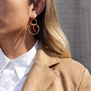 Gold multi-hoop earrings with red chili pepper pendant shown on a model
