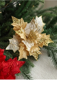 Glittery artificial Christmas flowers on pine branches with white plush background