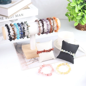 Detailed display of assorted natural gemstone bracelets with obsidian and amethyst stones