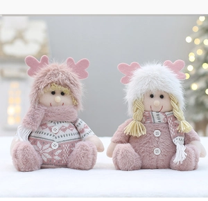 Detailed view of plush Christmas dolls with pink reindeer hats and knit sweaters