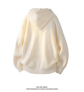Back view of cream knit hoodie featuring textured vertical ribs and relaxed fit design