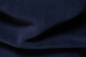 Detailed macro view of soft navy blue polar fleece fabric texture for thermal hoodie