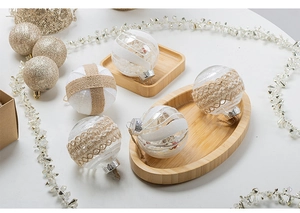 Detail of luxury white and champagne gold Christmas baubles with lace and glitter textures