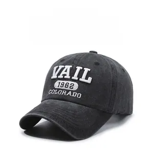 Macro detail of white embroidery on charcoal grey washed cotton baseball cap