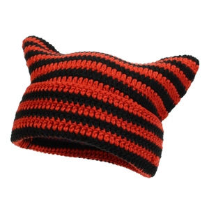 Detailed close-up of handmade red and black striped knit hat with cute cat ears