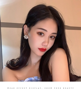 Floral crystal stud earring worn by model showing elegant sparkling design