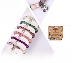 Detail of natural stone bracelets with silver apple charm and teacher appreciation gift card