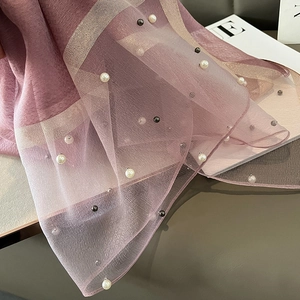 Detail of lavender silk scarf featuring faux pearl accents and shimmering silver stripes