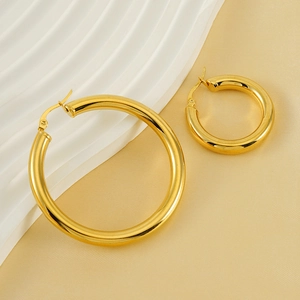 Chic 18K gold plated hollow hoop earrings in two sizes on a white display stand