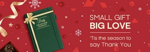 Close-up of dark green Gratitude Journal with gold foil lettering and festive bow