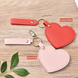 Portable heart-shaped leather mirror keychain with gold hardware and fine stitching