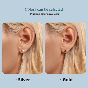 Polished silver and gold teardrop stud earrings worn by a model in a side profile view