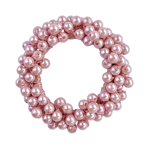 Detailed view of pink pearl hair tie with woven beaded texture for ponytails