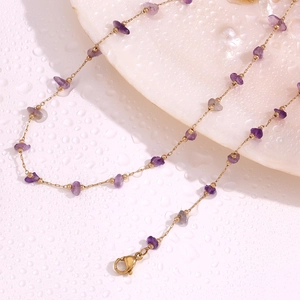 Detail of 18K gold plated necklace with purple amethyst stones and lobster clasp