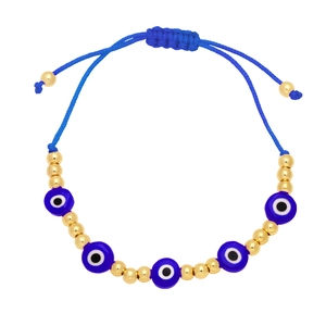 Detail of bohemian evil eye bracelet featuring gold beads and adjustable blue woven cord