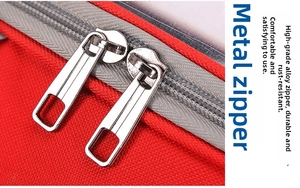 Detailed close-up of premium red pet carrier with durable silver alloy double zippers
