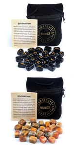 Detail of Rune stones sets with gold engraving, velvet pouch and divination guide card