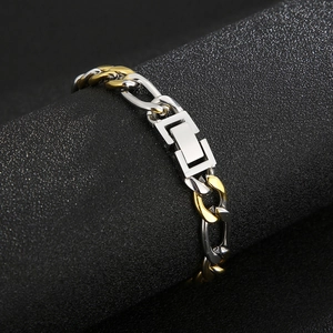 Macro shot of two-tone gold and silver Cuban chain link bracelet on a display stand