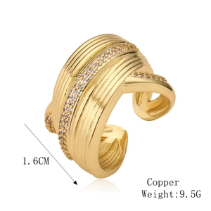 Macro detail of gold-plated copper open ring with zircons and textured finish