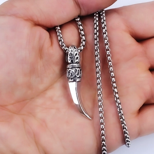 Vintage silver wolf tooth pendant necklace on box chain held for size reference