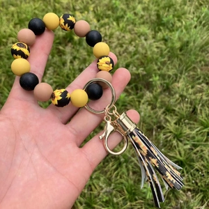 Portachiavi bracciale in perline di silicone girasole con nappa e anello dorato