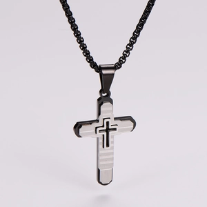 Close-up of a three-layer stainless steel cross pendant with textured horizontal stripes