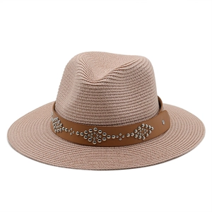 Detail of woven straw fedora with brown leather strap and silver rivet pattern