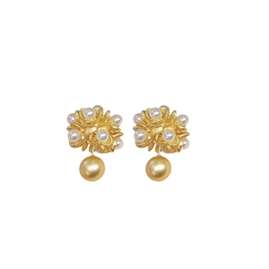Vintage gold metal flower pearl drop earrings with matte finish on white background