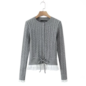 Women's gray cable knit cardigan with white lace trim and waist tie bow detail