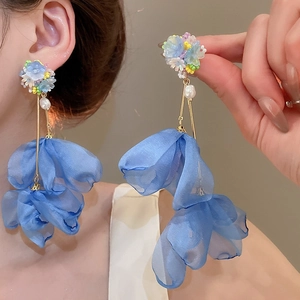 Detail of blue fabric petal drop earrings with white pearls and beaded flower studs