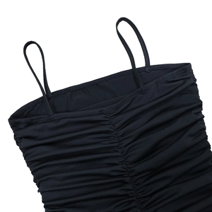 Detail of slim straps and ruched texture on a black fitted bodycon maxi dress