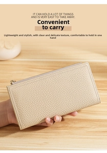 Slim long leather wallet in beige pebble grain finish with gold zipper held in hand