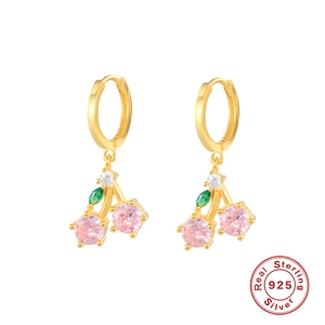 Macro shot of 925 sterling silver cherry earrings with pink and green gemstones