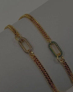 Close-up of punk gold Cuban choker links with sparkling green and clear rhinestones