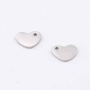 Close-up of polished silver heart-shaped stainless steel charms for DIY jewelry making