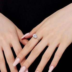 Close-up of S925 sterling silver ring with large oval halo diamond on hand