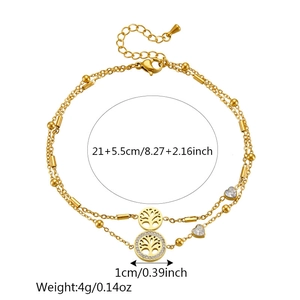Double-layered golden tree of life and heart anklet with crystal accents on white background
