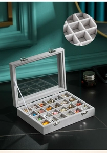 Detailed macro view of gray velvet jewelry organizer box with 24 compartments for small items