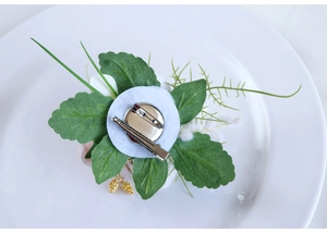 Détail de l'arrière de la boutonnière de mariage avec épingle de sûreté et pince à cheveux
