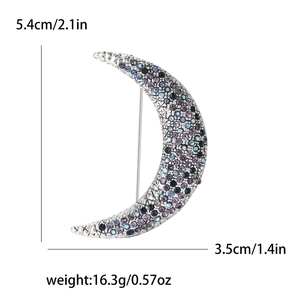 Detail view of crescent moon brooch with blue and purple rhinestones and size measurements
