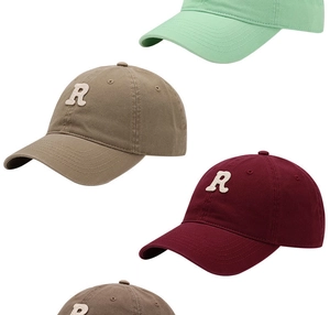 Detail view of cotton baseball caps with embroidered R letter in four classic colors