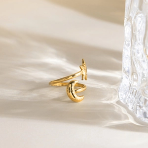 Close-up of 18K gold plated celestial wrap ring featuring star and moon charms