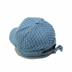 Detail view of denim baseball cap showing diamond distressed texture and metal buckle
