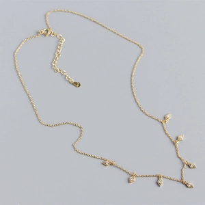 Detailed view of the gold S925 silver necklace with rhombus zircon pendant charms
