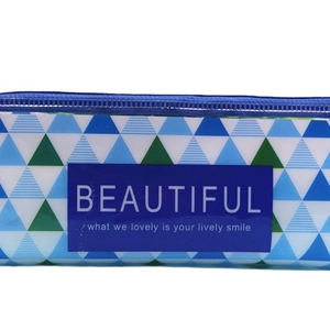 Transparent pencil case with geometric blue and green triangle patterns and zipper