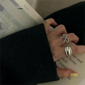 925 Sterling Silver bow tie and wide band ring set worn over a black sleeve background