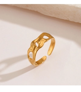 Detail of gold-plated stainless steel open ring with irregular hammer texture and wavy edges