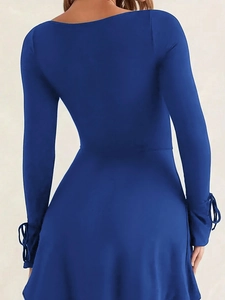 Detailed back view of royal blue dress featuring elegant lace-up bow tie sleeve cuffs