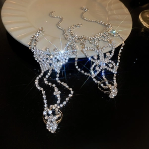 Macro detail of silver butterfly slave bracelet with shimmering rhinestones and tassels