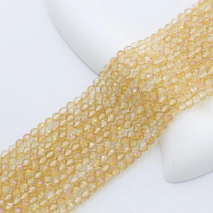 Macro detail of 4mm faceted champagne glass beads with aurora shimmer for jewelry making